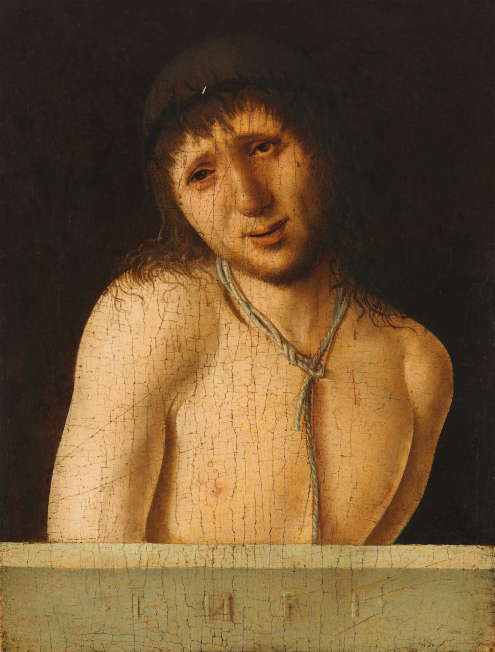 A close-up Renaissance painting depicts Christ half-length against a dark background, his bare torso softly lit, head tilted and eyes lowered in a quiet, sorrowful expression beneath a crown of thorns.
