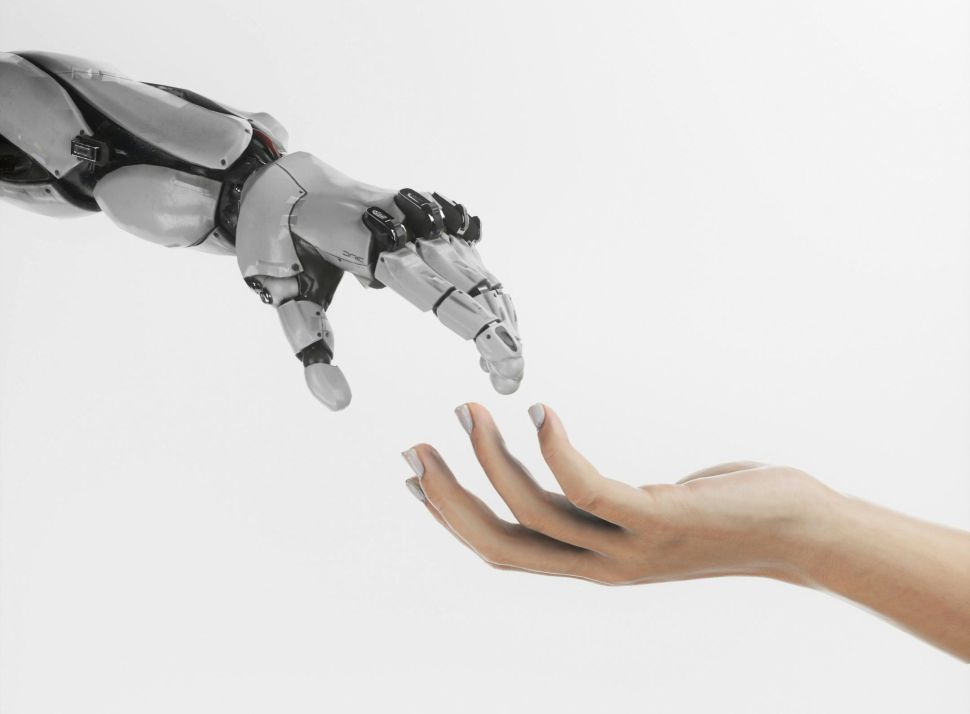 A robot hand approaching a human hand