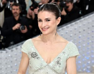 Chloe Malle wearing a low-cut pale green evening gown.